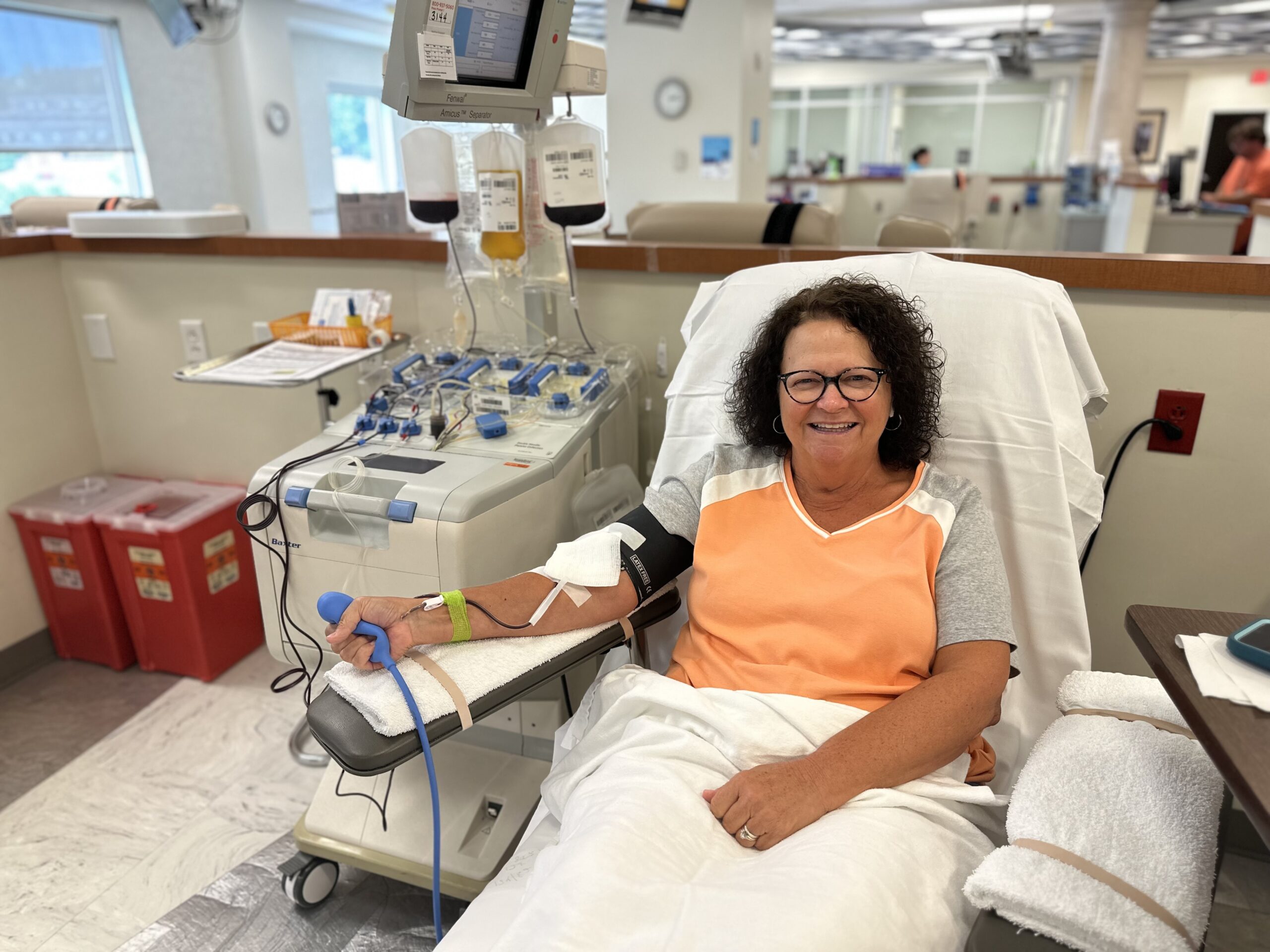 woman smiling as she donates platelets